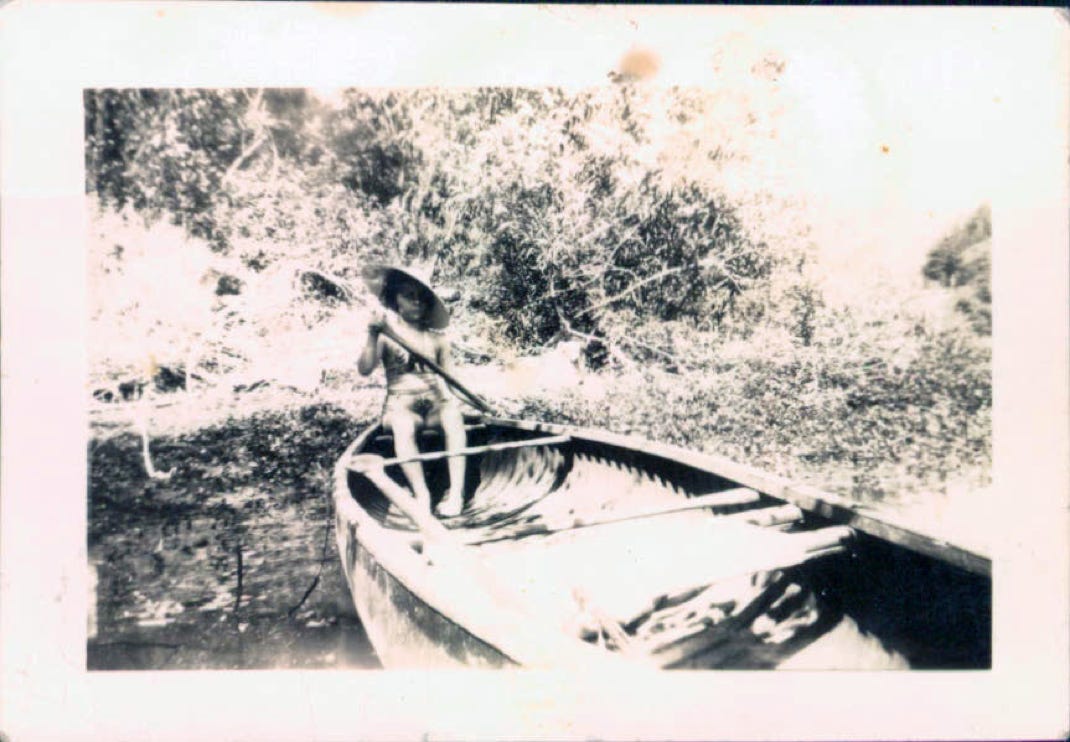 Grandma Marion as a girl in a canoe on the Russian River new Oddfellows Bridge